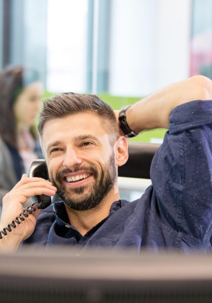 Smiling,Mid,Adult,Businessman,Talking,On,Phone,In,Office